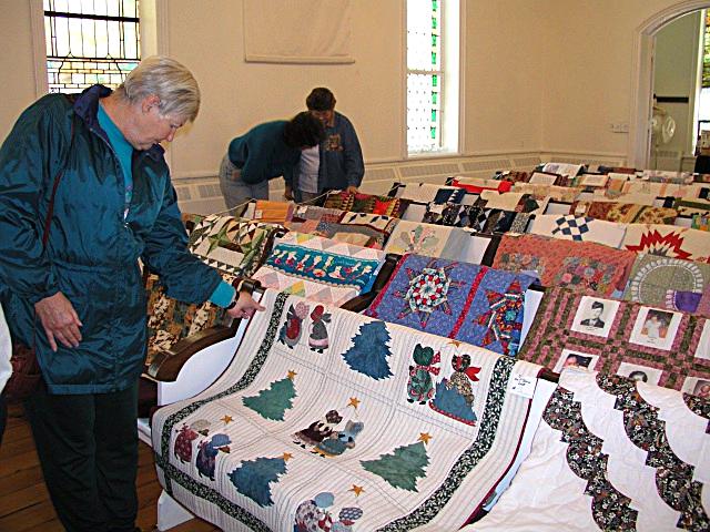 Grandma checks out a quilt shown in front of her Stack-N-Wack snowman quilt.