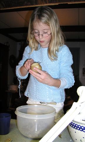 Grace peels potatoes