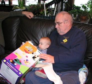 Grandpa helps Thomas open his gift