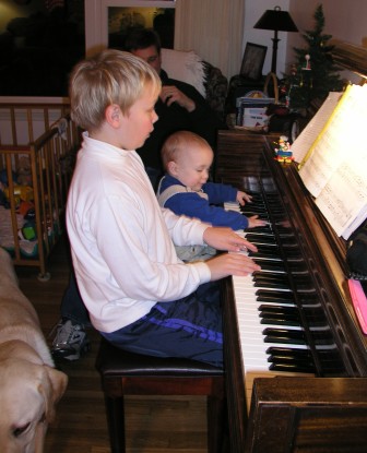 Thomas helps Jeffery with his piano practicing