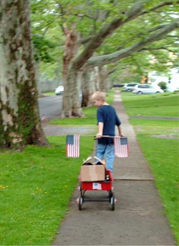 Jeffery helps set out flags along Charlotte Street