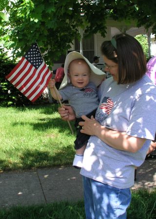 Thomas enjoys waving the flag at the Memorial Day Parade