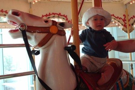 Thomas's first carousel horse ride - with Bethan's support