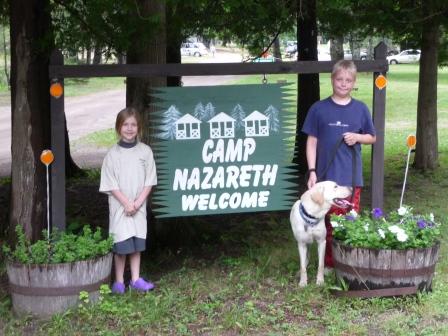 Camp Nazareth sign and Jeff with his two counselors and some of his cabin mates.