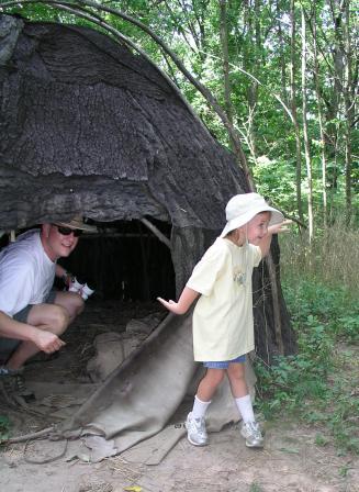 Bethan "walking like an Indian" and Jeffery in front of hut