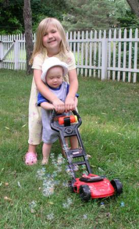 Thomas helps mow the lawn