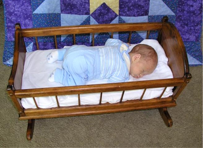 Still fitting in the baby doll cradle that Grandpa made
