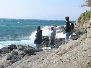 Richard, Nathaniel, and Nic watch waves crashing on the rocks.&nbsp; 
