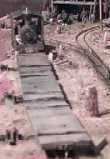 A empty train of log flats being switched in the yard at Broughton Vale