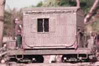 Crew members and gear are hauled around the tramway on this tiny log caboose