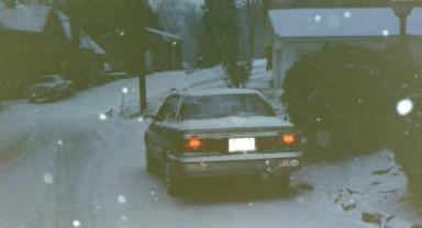 Our car in the snow, outside our house.