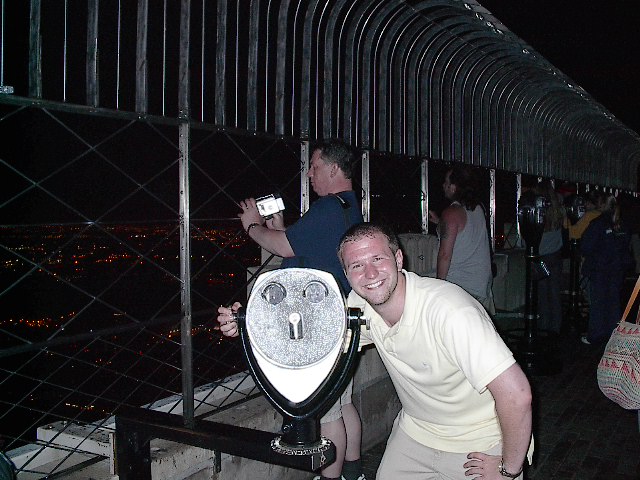 Luke smiling with another smiling face at the empire state building