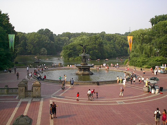 Central Park fountain with people in rowboats in the background