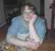 This is a recent picture of me at the kitchen table in my house dress. Taken 7/6/05