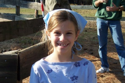 Big smile on young girl visiting farm