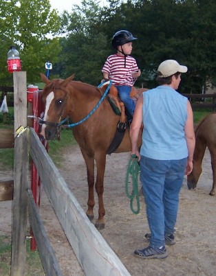 Arianna with young student during riding lesson