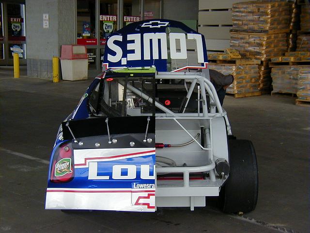 This is the rear of the cutaway car, just to show you how things looked. In the rear, you can see the braided fuel line running from the filler on the left side of the car into the fuel cell. Also there's a clear plastic hose running out to the left "tail light" that basically blows fuel out it if the tank ever gets over-pressured.