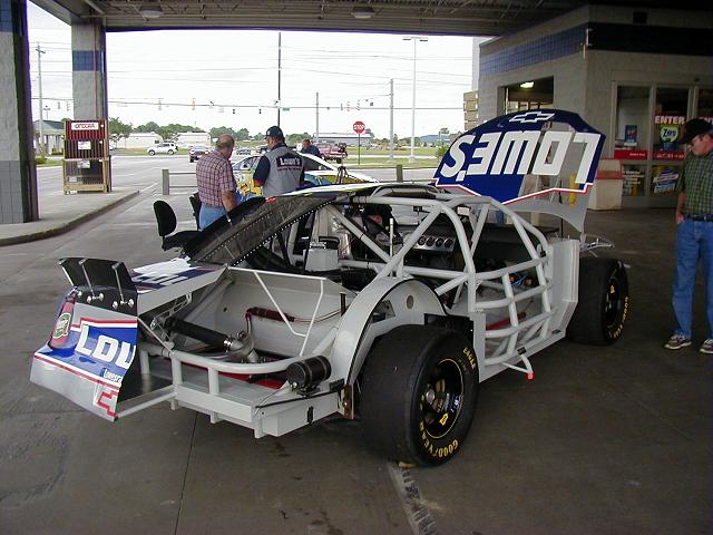 This is the right side rear of the cutaway car, as you can tell. This stuff is really cool. I must say, I saw an engenious idea on those cars. Alot of times, if the aerodynamics of the car isn't right, or the ride is too rough, they have to change the spring rates. Now on a normal car, you'd do this by getting under it, pulling off the tire, dropping the rear axle, pulling out your suspension, and putting new springs in, put the axle back on, and put the tire back on, and hope it works right. If its not to your liking, you have to take it off and do it again. Not NASCAR buddy...they have a threaded plate on a big screw. If you don't like the ride, you just put your 1/2 inch drive socket wrench on it, give it a few turns, and the car acts completely different. I'd say whoever invented that is probably patting themselves on the back. They deserve it too. 
