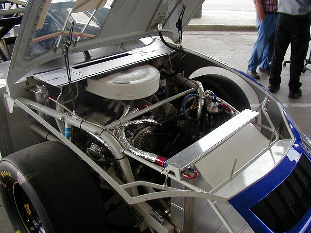 This is the engine that they use in every one of Hendrich's owned cars. And similar configurations exist in all the Chevies of NASCAR. These engines pump out about 800 horsepower, and there's two really cool things about them. Number one, if you stand on the left side of the car where the exhaust ports are, and that thing is running, it will rattle you right down to your soul. Yup, that's how loud they are. And number two, put your hand on your desk. Feel how nice and smooth it is? No vibrations right? Well...if it is, you've got some serious problems with your desk...anyways, that's how these engines run! They're balanced so well, they vibrate as much as your desk does. Everything is perfectly balanced so that engine can make those 9000 rpm laps around the track and not blow up in short order. Now that is COOL!!!
