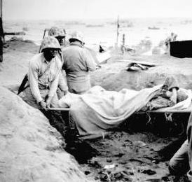 Marine helping carrying the wounded