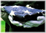 Folded American Flag being presented to a widow
