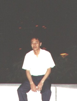 Sitting on a park bench.