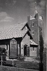 The completed church, with fence and notice board