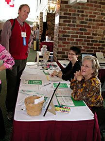 Tim Jebsen visits with TNT Administrtive Director Allison McCorkle and volunteer Mary Cox