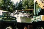 Cranes lifting boat