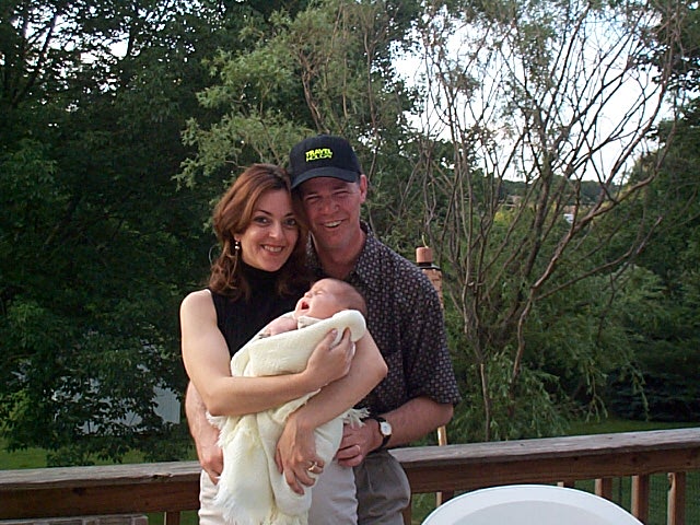 This is our family: our baby (Victoria Solenne the day she turned two months old), my husband, and myself.