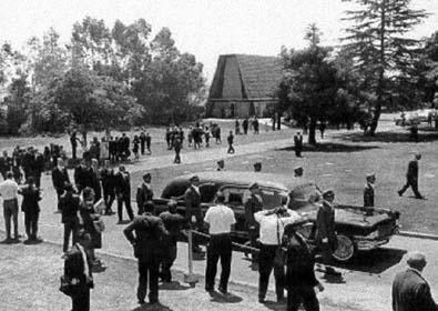 Abbott & Hast's 1962 Cadillac Eureka hearse carrying Marilyn Monroe's body leads the funeral procession from Westwood Village Cemetery Chapel to the crypt.