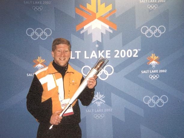 With the Olympic Torch.