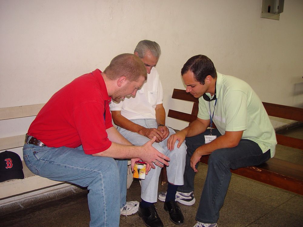 Praying with a Brazilian man to accept Christ.