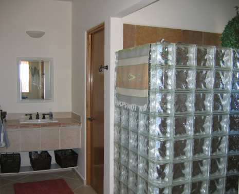 Huge Glass Block Shower, "His" Vanity further on.