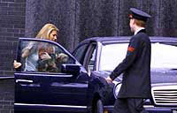 Maxima gets into a car