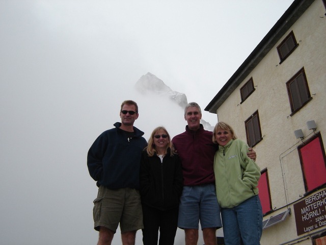 Click to enlarge:  us at the Berghaus Matterhorn, with the Matterhorn obscured by clouds in the background.