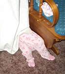 20050304_01w-Emily-7mo_legsunderCurtain.jpg