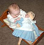 20050314_06b-Emily-8mo_withDolly_SittingInCradle.jpg