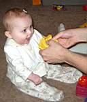 20050314_09w-Emily-8mo_laughingwhenDaddyMatt_SqueaksherBlock.jpg