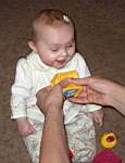 20050314_11b-Emily-8mo_laughingwhenDaddyMatt_SqueaksherBlock.jpg