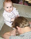 20050318_04b-Emily-8mo_playingwithDaddyMattHair_expandingbaldspot.jpg