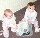 20050319_07b-CollectingforScoutingforFood_EmilyHiggins-8mo_EmmaleiReynolds-10mo_checkingdonations.jpg