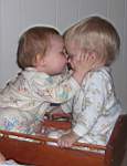 100_0549w_EmKissingMike_BothinCradle.jpg