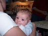 Curious eyes examining the world from the safety of Moms arms.