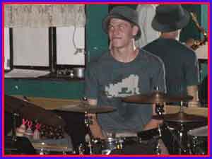 funk music drummer looking at outsider artist John Dog