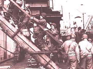 Soldiers board a ship in preparation of the D-Day invasion