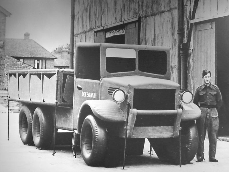 A soldier stands with a Hollywood- constructed prop truck, used in the clever Allied ruse to make the Nazi's believe the invasion would occur at Pas- de- Calais