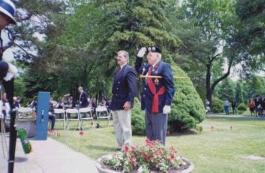 Veterans of D- Day salute the fallen in the mass graveyard overlooking the cliffs near Arromanches