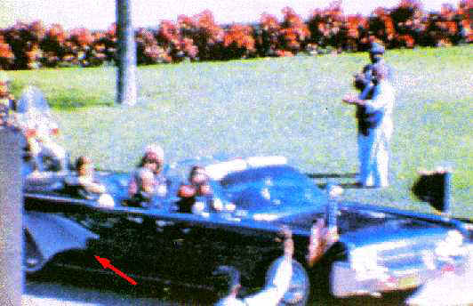 The umbrella man is shown in the lower-right hand corner of the image, where the red arrow points.&nbsp; Across the street in the white shirt is Dark Complected man as he raises his hand.