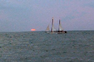 cropped picture of yacht sailing at sunset